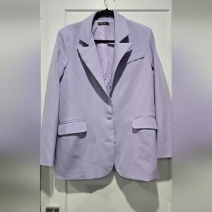 Oversized lilac blazer with matching skirt.